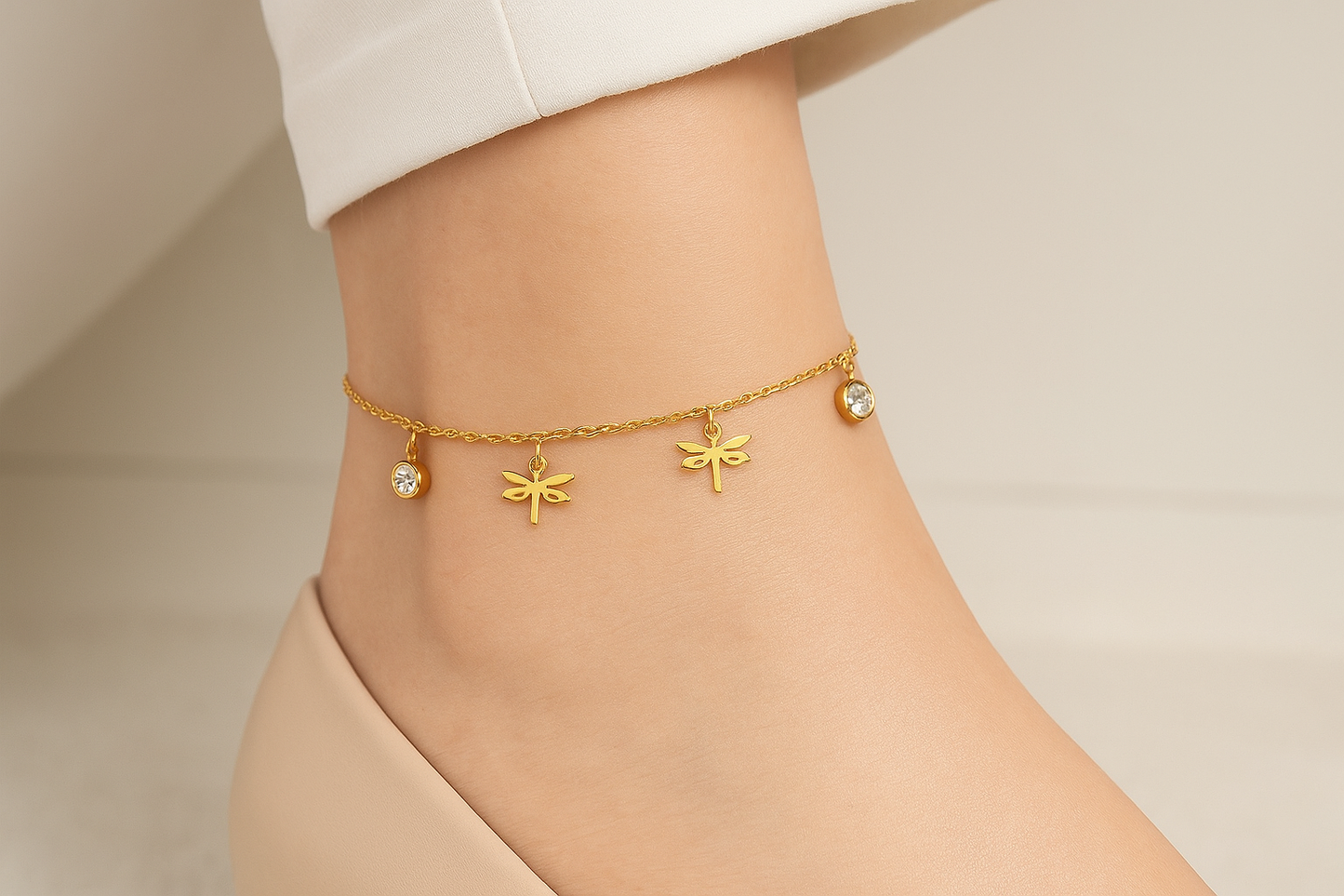 Professional lifestyle photography of a white female model wearing the golden dragonfly anklet