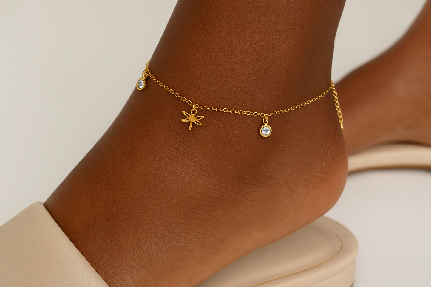 Professional lifestyle photography of an African American female model wearing the golden dragonfly anklet