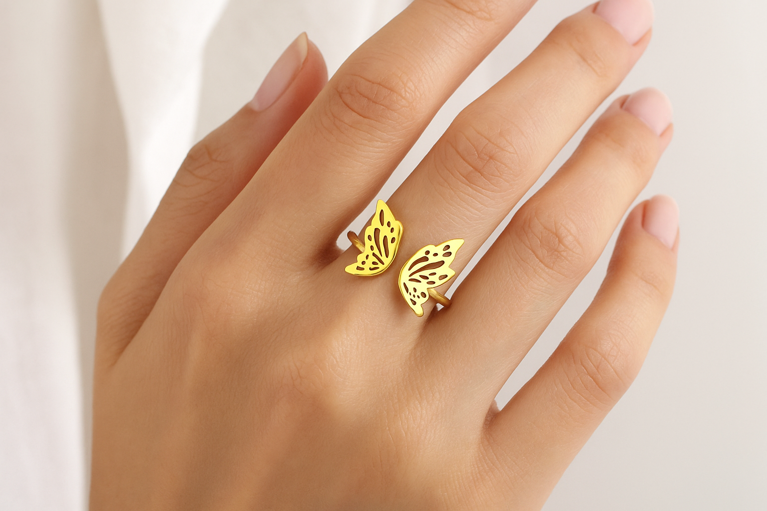 Professional lifestyle photography of a white female model wearing the gold butterfly ring