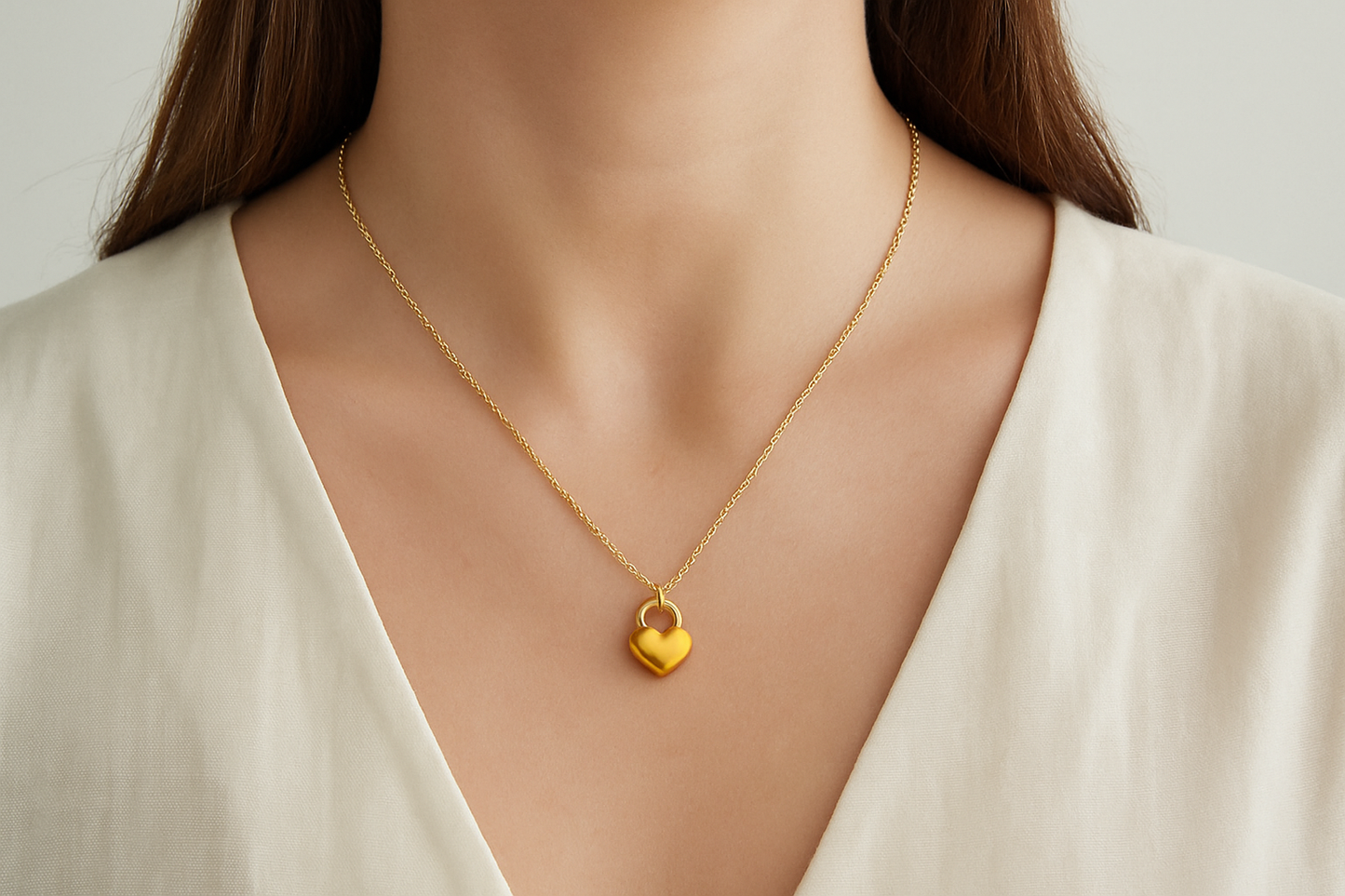 Professional lifestyle photography of a white female model wearing the golden heart padlock necklace