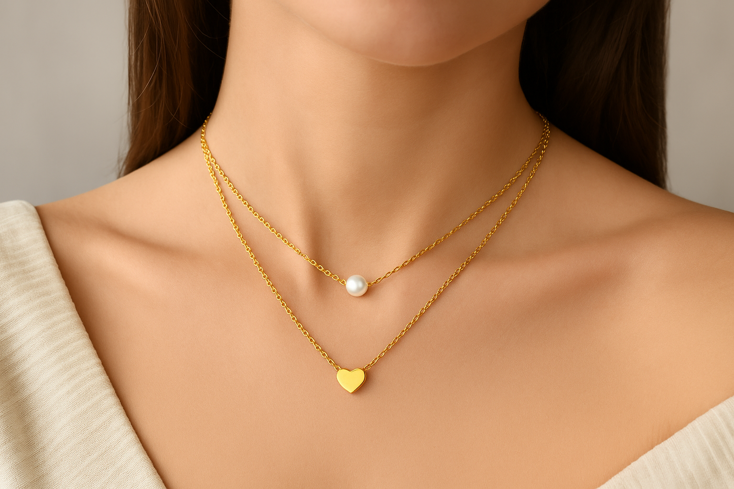 Professional lifestyle photography of a white female model wearing the layered pearl and heart necklace