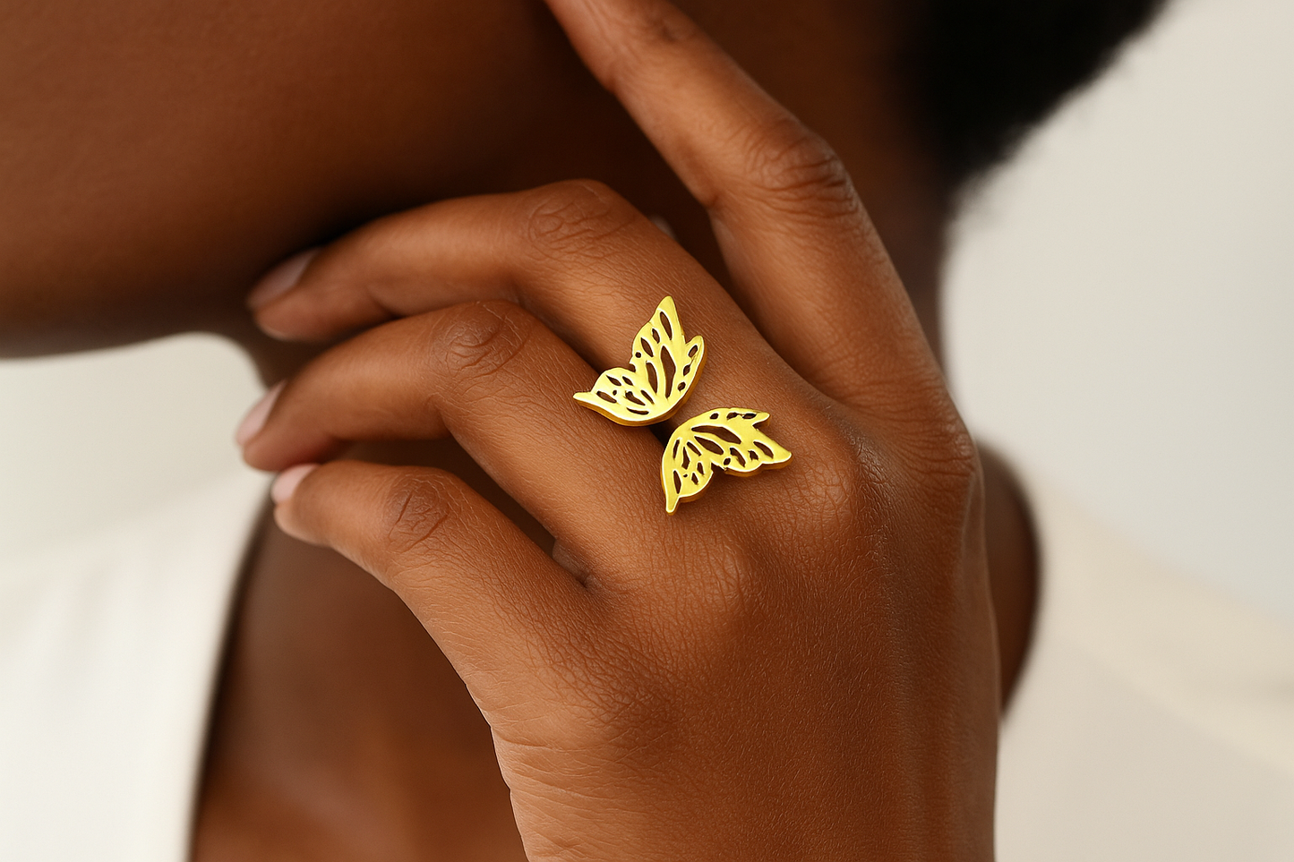 Professional lifestyle photography of an African American female model wearing the gold butterfly ring