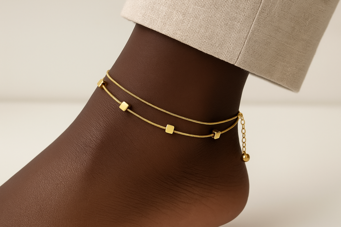 Professional lifestyle photography of an African American female model wearing the golden aura anklet